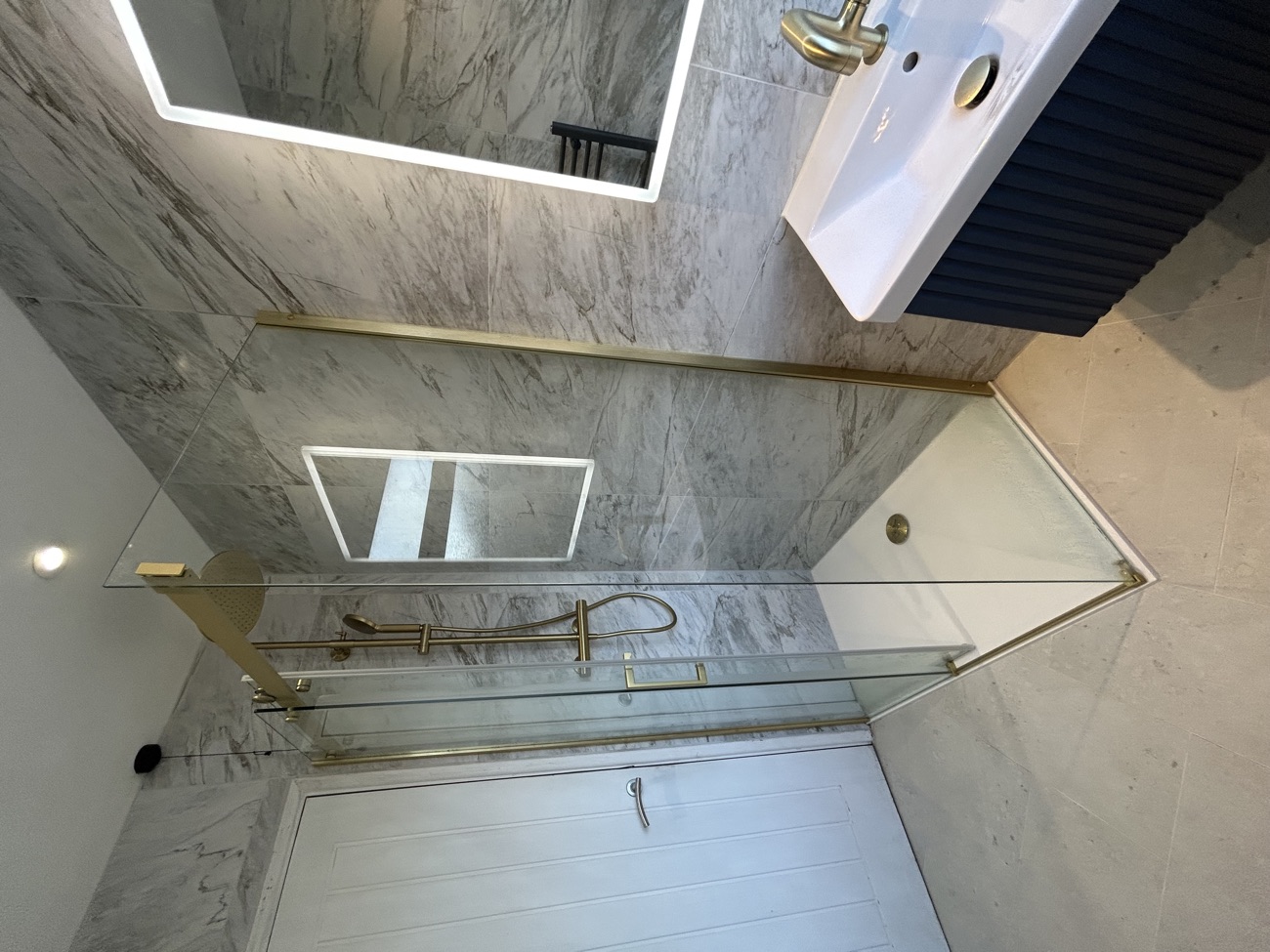 Marble walk-in shower from a complete bathroom renovation